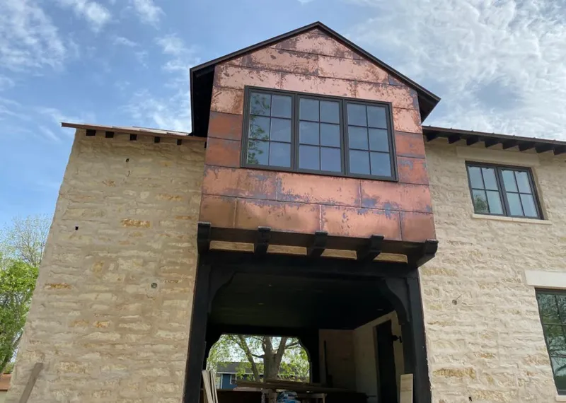 Copper metal panel facade on a stone building for Skylight Installation in Skiatook